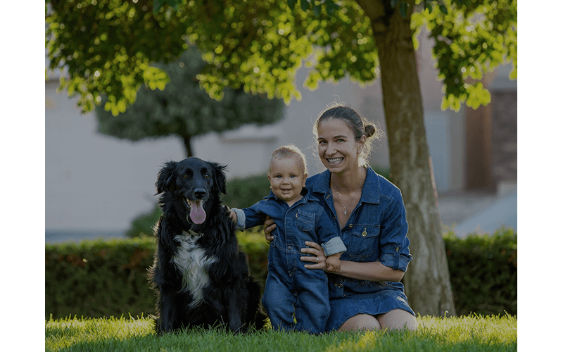 Woman, child, and dog smiling