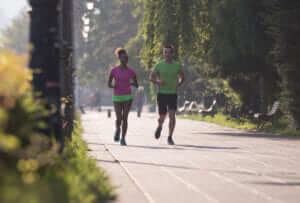 man and woman running outside